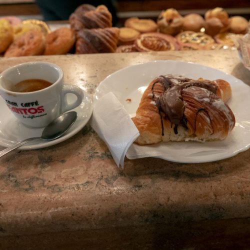 Italian breakfast - espress0o and pastry while standing at counter